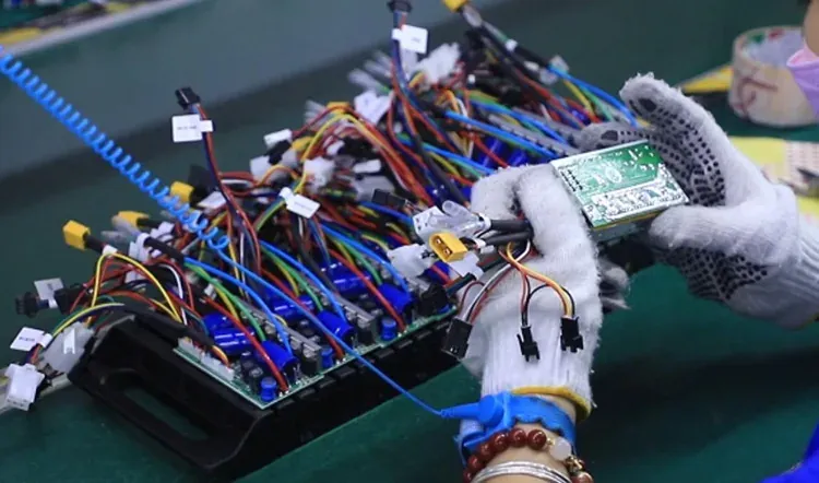 Electrical wiring and component work during vending machine assembly